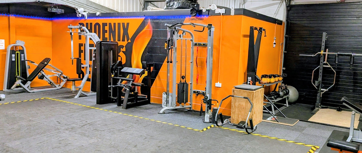 The Phoenix Fitness Settle mural above the strength machines